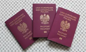 Trzy polskie paszporty, gotowe do podróży. Sprawdź wymagania paszportowe przed wyjazdem.