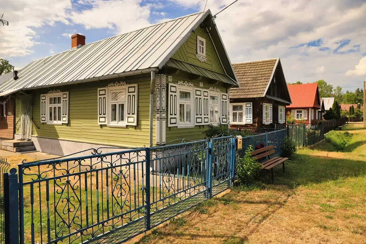 Kolorowe, drewniane domy z ozdobnymi okiennicami i płotami. Typowe nietypowe atrakcje Podlasia, gdzie czas płynie wolniej.
