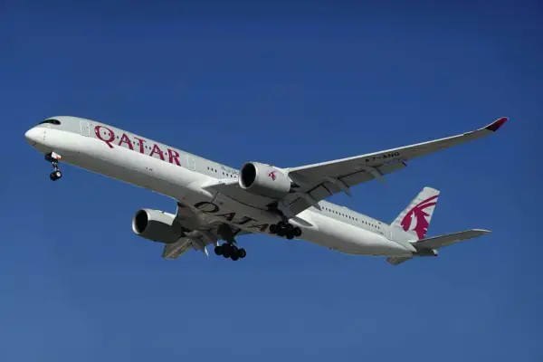 Samolot Qatar Airways z wysuniętym podwoziem, gotowy do lądowania. Pamiętaj o limitach bagażu podręcznego!
